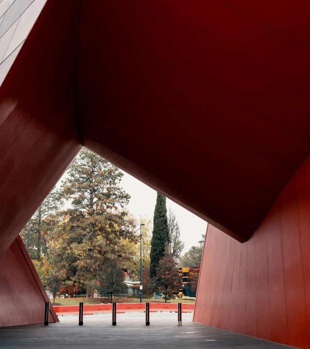 A contemporary architectural design in Canberra showcasing bold red shapes and dynamic structures.